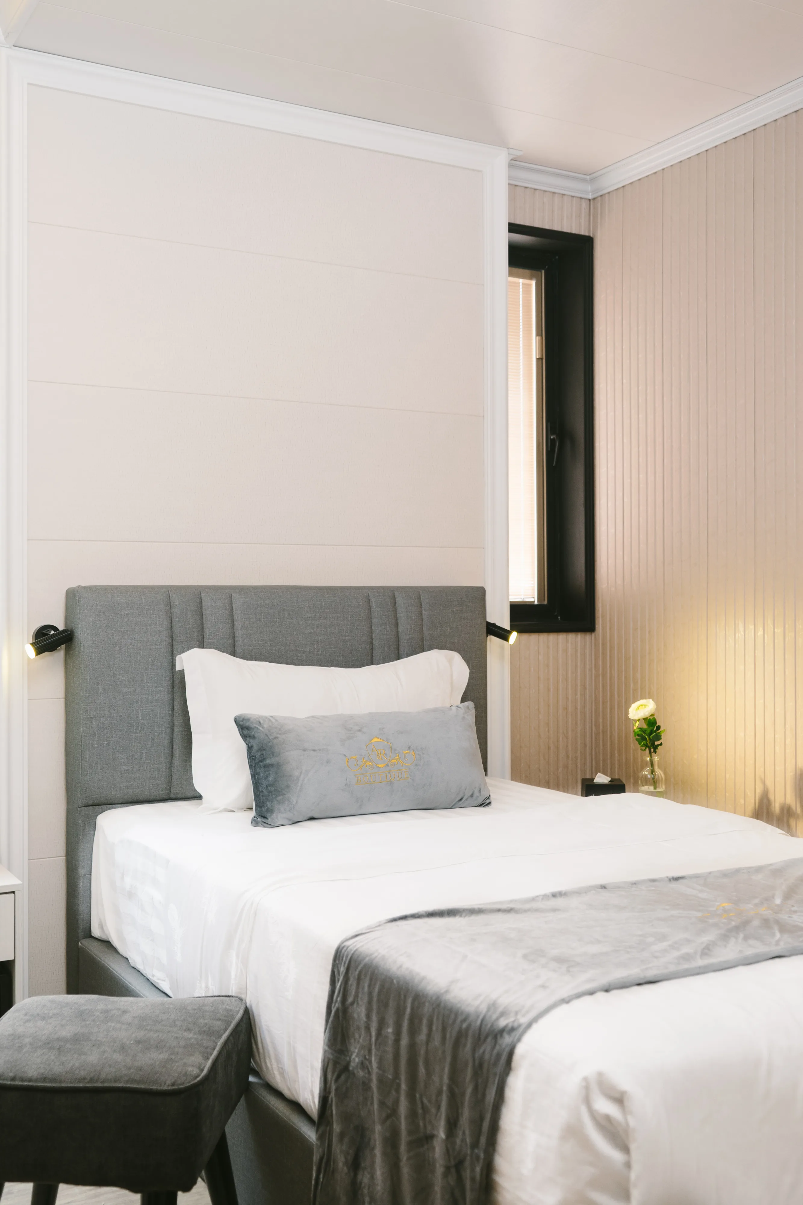 Deluxe Single bed with A&R Boutique logo cushion and reading lamp, Cheras