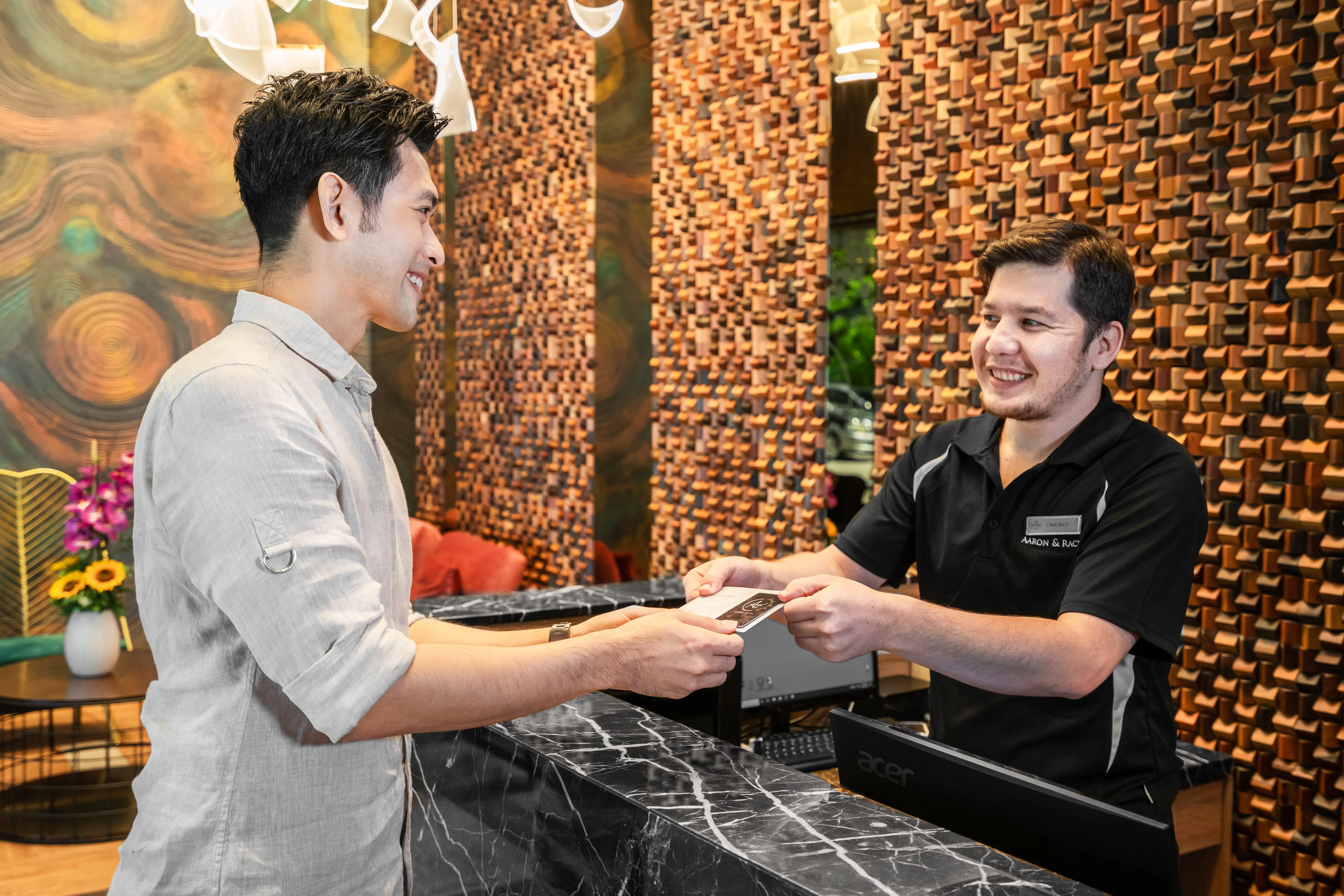 Check-in desk at A&R Urban Hotel with exposed brick wall